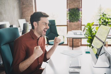 Sticker - Photo of handsome man winning scream celebrate sit tables coworking successful businessman wear brown formalwear nice creative light office