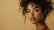 © Pete Garrison - Beauty portrait of african american woman with clean healthy skin on beige background. Smiling dreamy beautiful afro girl. Curly black hair