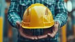 © Generative AI - Helmet is in hands of builder Hardhat for head protection Man builder smiles as he holds out his helmet Construction crew worker Hardhat to avoid accident Builder suggests wearing helm : Generative AI