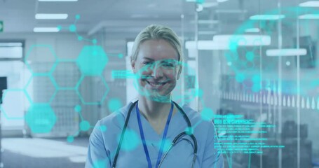 Wall Mural - Medical data and hexagonal shapes animation over smiling healthcare professional in hospital