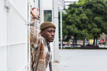 Stylish black man waiting on the city street