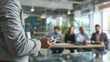 © Lull - Businessman presenting. A businessman giving a presentation to a group of colleagues in an office setting. He is holding a tablet and looking at his audience.