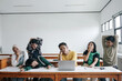 © Gatot - Multiethnic Asian Students Listening A Boring Lesson Sitting In A Desk At Classroom