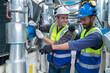 © Washburn - Engineers Collaborating and Smiling in Industrial Setting