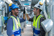 © Washburn - Engineers Collaborating and Smiling in Industrial Setting