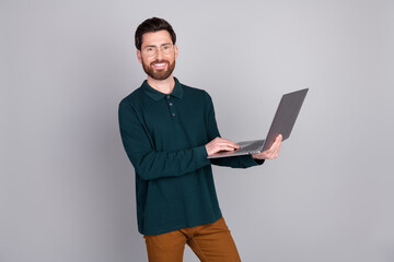 Canvas Print - Photo of successful attractive nice man manager wear trendy green clothes use gadget isolated on gray color background