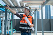 © Washburn - Engineer Inspecting Industrial Pipes on Rooftop