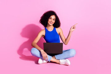 Poster - Photo of smiling girl sitting using netbook point finger copyspace isolated pastel color background