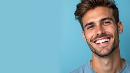 Close up a beautiful healthy smile of a young man on light blue background with copyspace