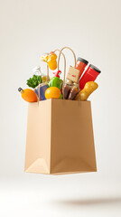 Vegetables and fruits groseries flying out the brown paper bag isolated on white background