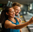 © Lumos sp - gym sport fitness exercise health woman training phone selfie coach trainer instructor personal photo portrait self posing camera healthy boyfriend girlfriend love