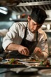 © Lakkhana - Passionate chef plating a dish in a gourmet kitchen