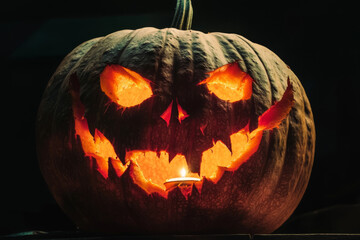 Glowing Jack-o'-Lantern with Evil Grin and Candle