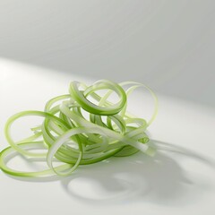 Poster - Green vegetable ribbons curled in a messy pile on a white background.