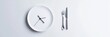 © Mark - The concept of time-restricted eating and disciplined nutrition is symbolized by a clock on a plate with cutlery.