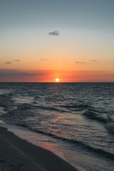 Wall Mural - Varadero, CUBA - April 08, 2023: Varadero Beach.The famous beach of Varadero in Cuba with a calm turquoise ocean and clouds in the sky. Sunset time