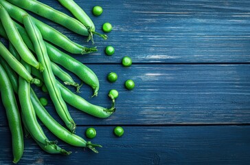 Sticker - A bunch of green beans and green peas are on a wooden table