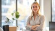 © 69 - Businesswoman in her office, casually posed by her desk with natural light from the window, corporate photography emphasizing professionalism.