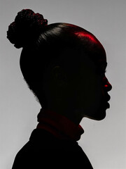 A portrait of a woman with dark skin and black hair, wearing a red and black outfit. Silhouette portrait