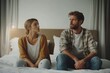 © Vooglo.com - Annoyed Caucasian husband sit apart on bed with offended wife keep silence after fight family