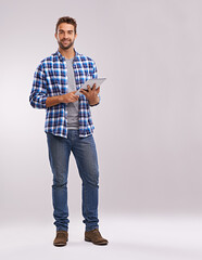 Poster - Typing, tablet and man with connection, portrait and communication on a grey studio background. Person, mockup space and model with technology or digital app with social media, smile and website info