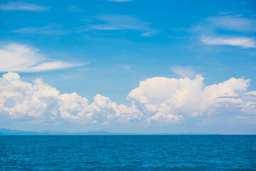 Blue sky with fluffy cloud in sea background