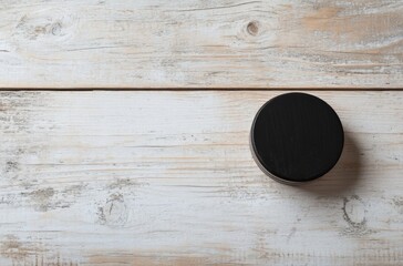 Wall Mural - Black Round Container on a White Wooden Surface