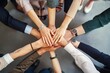 © Viktor - Close-up of business people hands in top view. Diverse group of men and women in casual attire, fingers intertwined, forming circle. Symbolizing teamwork, cooperation, and unity in corporate world.