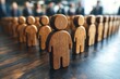 © Worrapol - Wooden Figures: Unity in a Diverse Workforce: Wooden figures stand in a line, symbolizing unity and diversity in the workplace. A powerful image conveying the importance of a strong team.