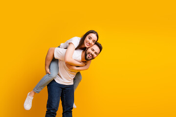 Sticker - Photo portrait of lovely young guy girl hugging piggyback dressed stylish white garment isolated on yellow color background