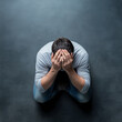 © ChaoticDesignStudio - Man sitting on the floor, head in hands, expressing despair
