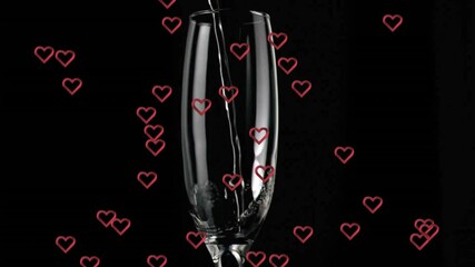 Canvas Print - Pouring liquid into glass with red hearts animation over black background