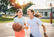 © Louis-Photo - two childs girls in sportswear playing basketball game