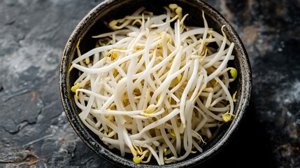 Wall Mural - Close up view of a bowl filled with fresh vibrant and nutritious bean sprouts ready to be added as a healthy and flavorful ingredient in a variety of culinary dishes such as stir fries salads