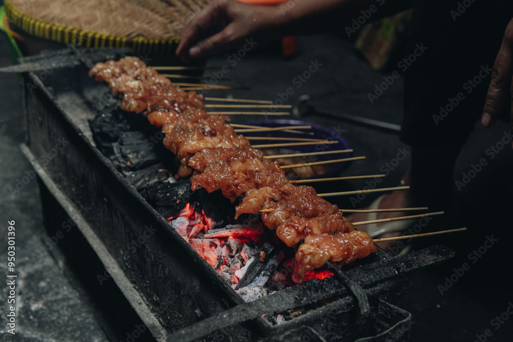 The process of making Indonesian chicken satay in traditional way using ...