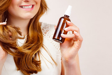 Poster - Woman applying hair cosmetic