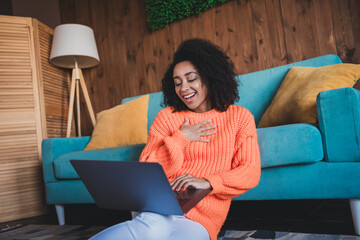 Poster - Photo of positive excited woman dressed orange pullover relaxing home talking modern device indoors house apartment room