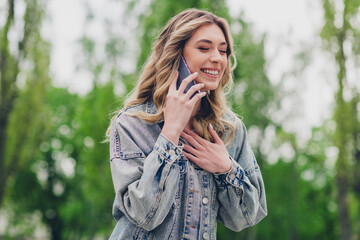 Sticker - Portrait of nice young girl chatting phone laugh wear denim jacket pastime walk city downtown park outdoors