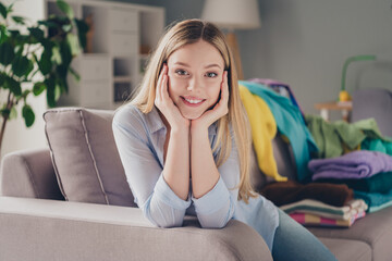 Photo of adorable sweet lady wear blue shirt enjoying organaze clothes indoors room home house