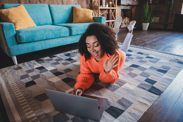 Poster - Photo of positive good mood woman dressed orange pullover relaxing home waving hi communicating device indoors house apartment room