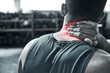 © peopleimages.com - Man, fitness and neck pain with red glow at gym with muscle tension and strain. Male person, workout and exercise with ache, injury and inflammation on training or warm up for health and wellness