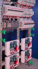 Poster - An electric switchboard with modules for protection and control of electrical loads, mounted on din rails.