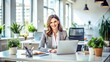 © Sirinporn - Professional woman sitting at modern desk, surrounded by laptops and papers, focused on work with a calm and confident expression in a bright office space.