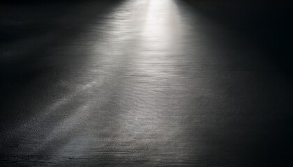 Wall Mural - light casts dramatic effects over a textured surface in an empty moody setting