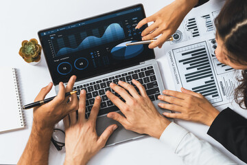 Poster - Top view workspace of analyst team uses BI Fintech display laptop to analyze financial data . Business people analyze BI software technology dashboard power for insights business power. Prudent