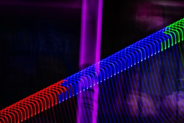 Wall Mural - a series of colorful lines are displayed in a dark background. the colors are red, blue, and purple.