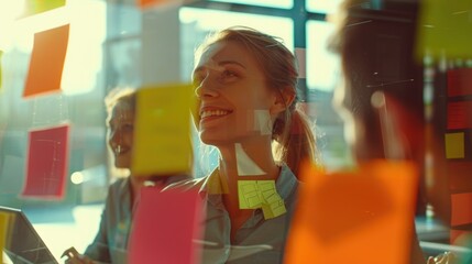 Poster - A woman stands in front of a glass wall covered in colorful post-it notes, providing a creative and organized workspace