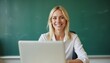 © ahmed - Empowering white blonde female teacher at desk with laptop for World Teachers' Day
