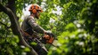 © afridwi - Professional Arborist Trimming a Tree with a Chainsaw in Safety Gear, Surrounded by Lush Green Leaves