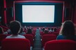 © InfiniteStudio - People in red chairs watching a movie performance on a blank screen in a dimly lit cinema hall